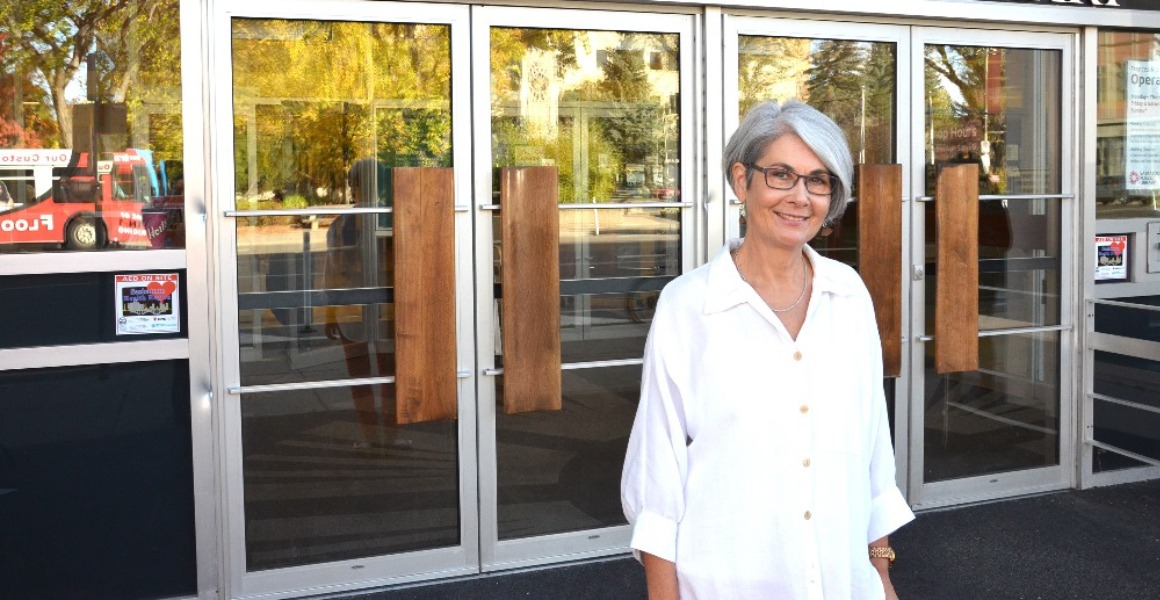 photo: Katherine Lawrence standing in front of library doors.